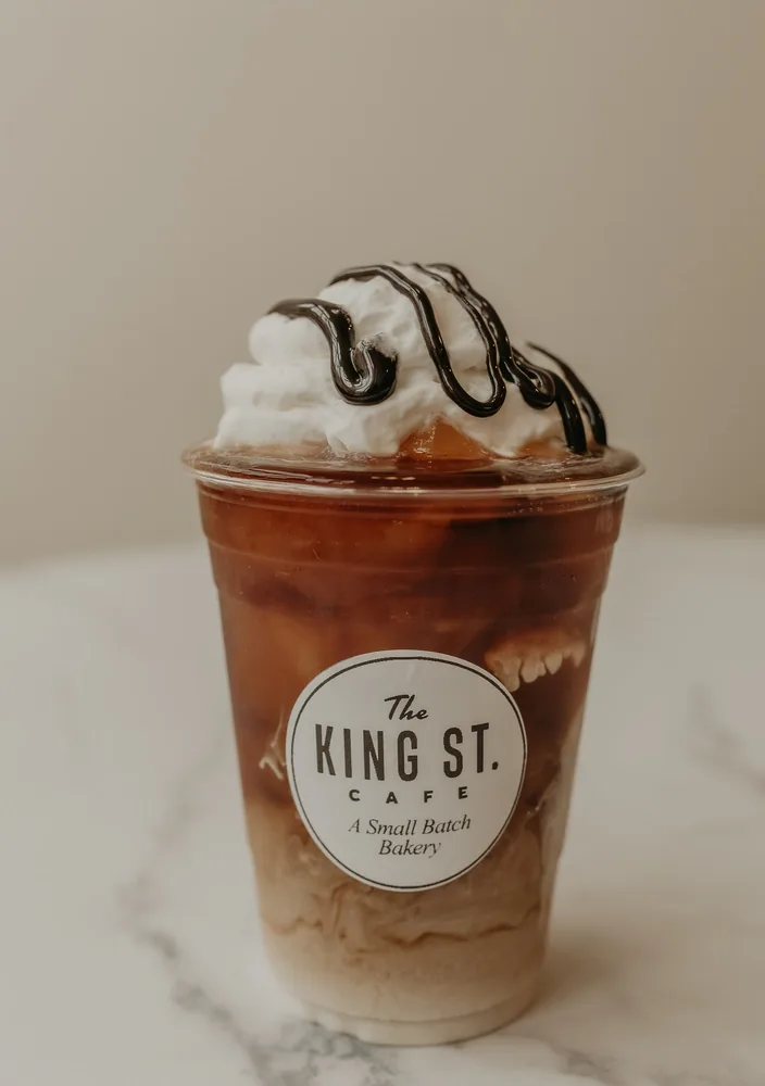 An iced coffee in a King St. Cafe cup